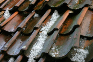 Old roof filled with hail stones - hail damage on a residential roof.